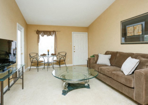 a living room with a couch and a glass table