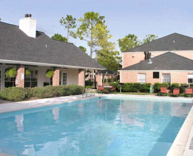 a large swimming pool in front of a house