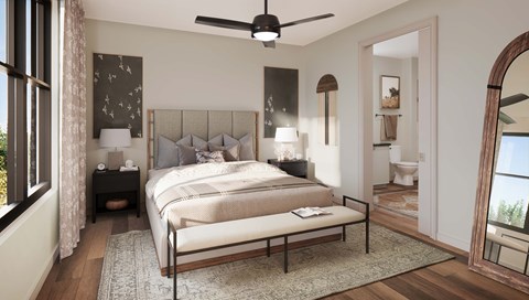 A bedroom with a large bed and a ceiling fan.