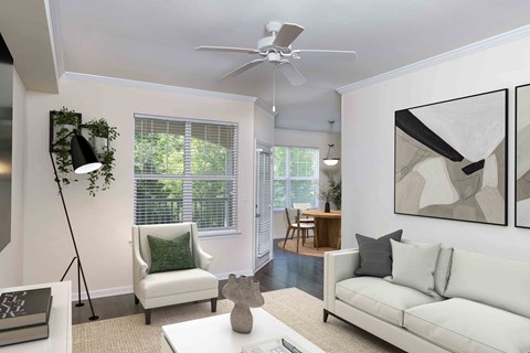 an open living room with white furniture and a ceiling fan