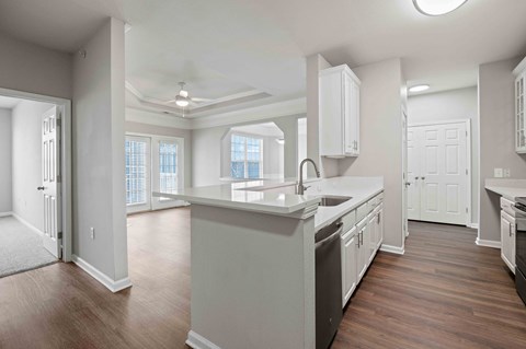 A spacious kitchen with white cabinets and a large island.