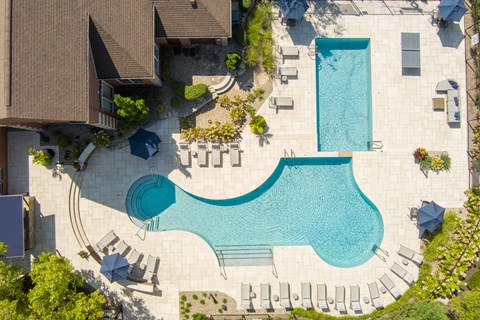 An aerial view of a house with a pool.