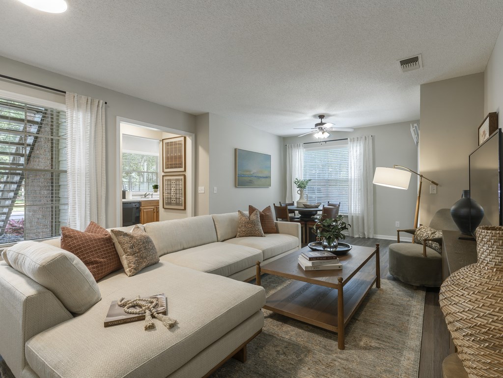 Longwood Sabal Park Apartments resort-inspired pool and expansive sundeck a living room with a white couch and a coffee table.