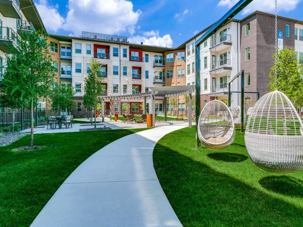 Sagemont Apartments Irving Texas expansive outdoor greenspace with lounge areas