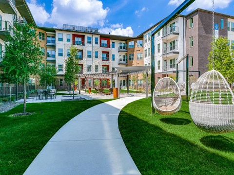 Sagemont Apartments Irving Texas expansive outdoor greenspace with lounge areas