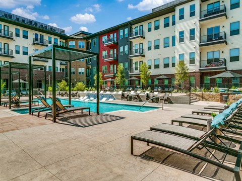 Sagemont Apartments Irving Texas resort-style pool with cabanas and lounge seating