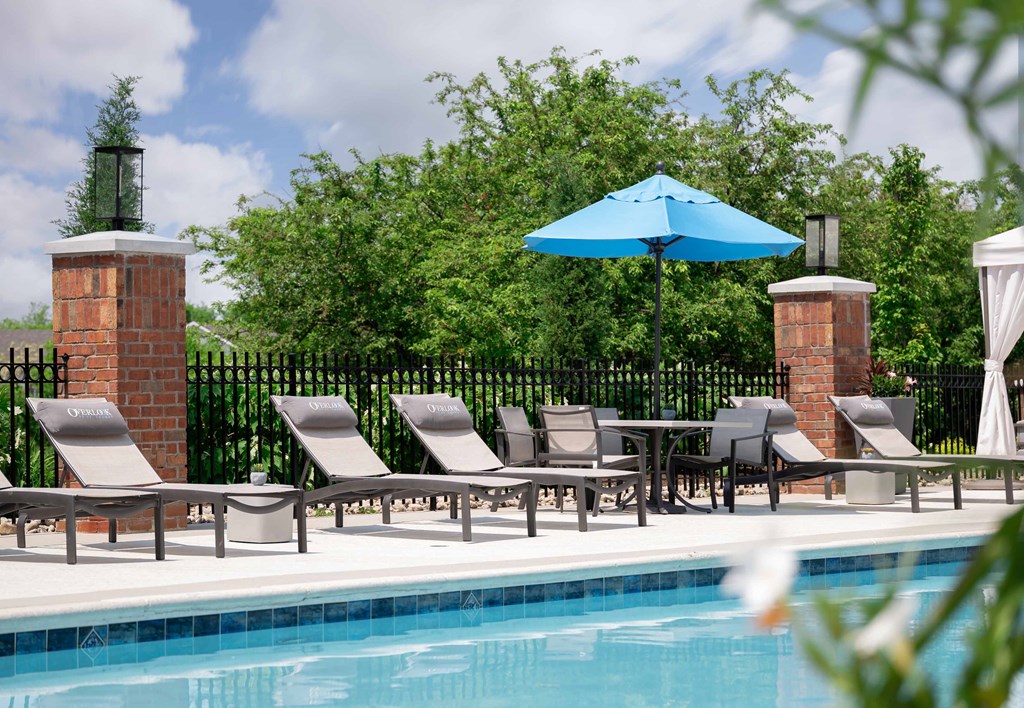 The Overlook at St. Thomas Apartments Louisville poolside lounge chairs
