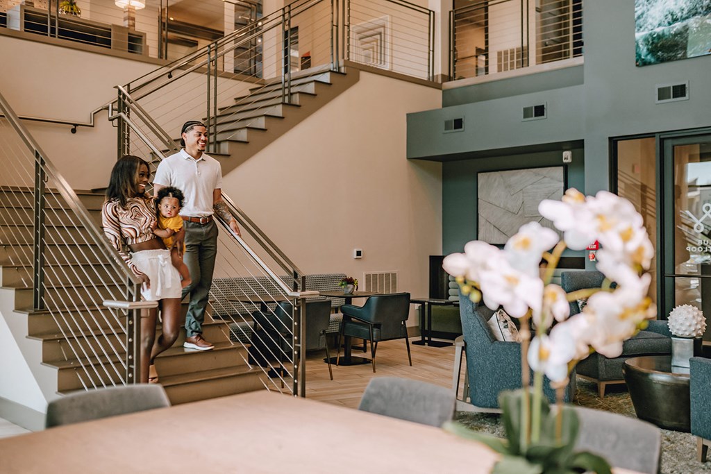 a family walking down the stairs into a living room