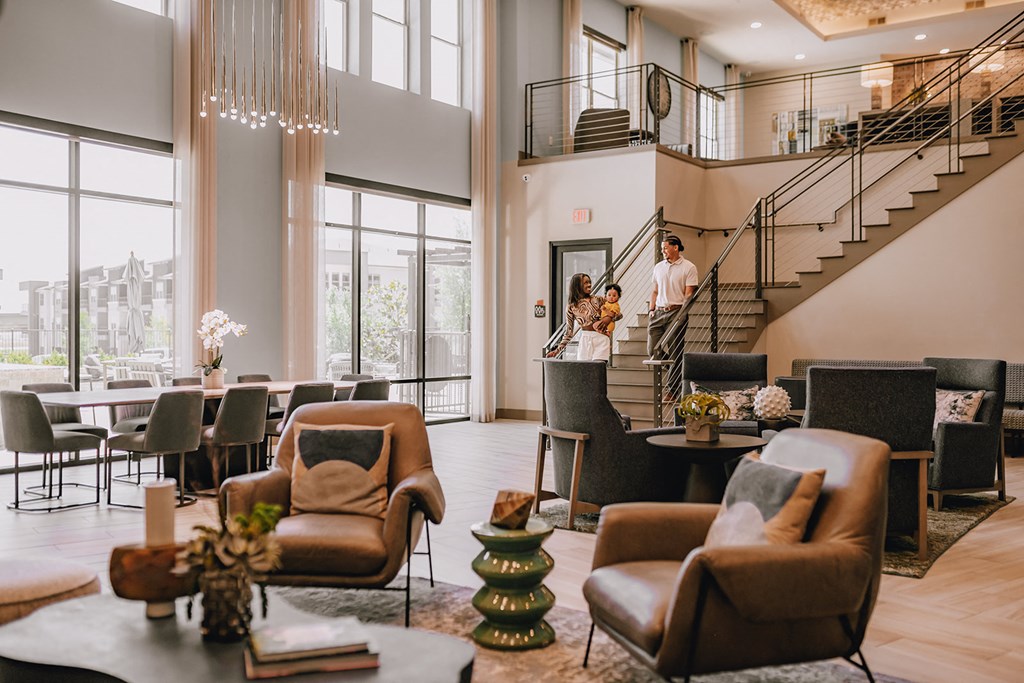 a bride and groom are walking down the stairs in the lobby of a hotel