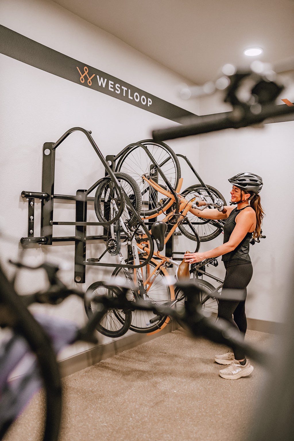 a woman working on a bike in a bike gym