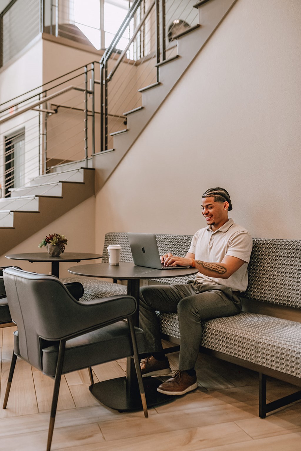 a man sitting on a couch with a laptop computer
