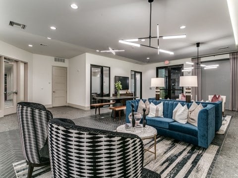 a living room with couches and chairs and a table