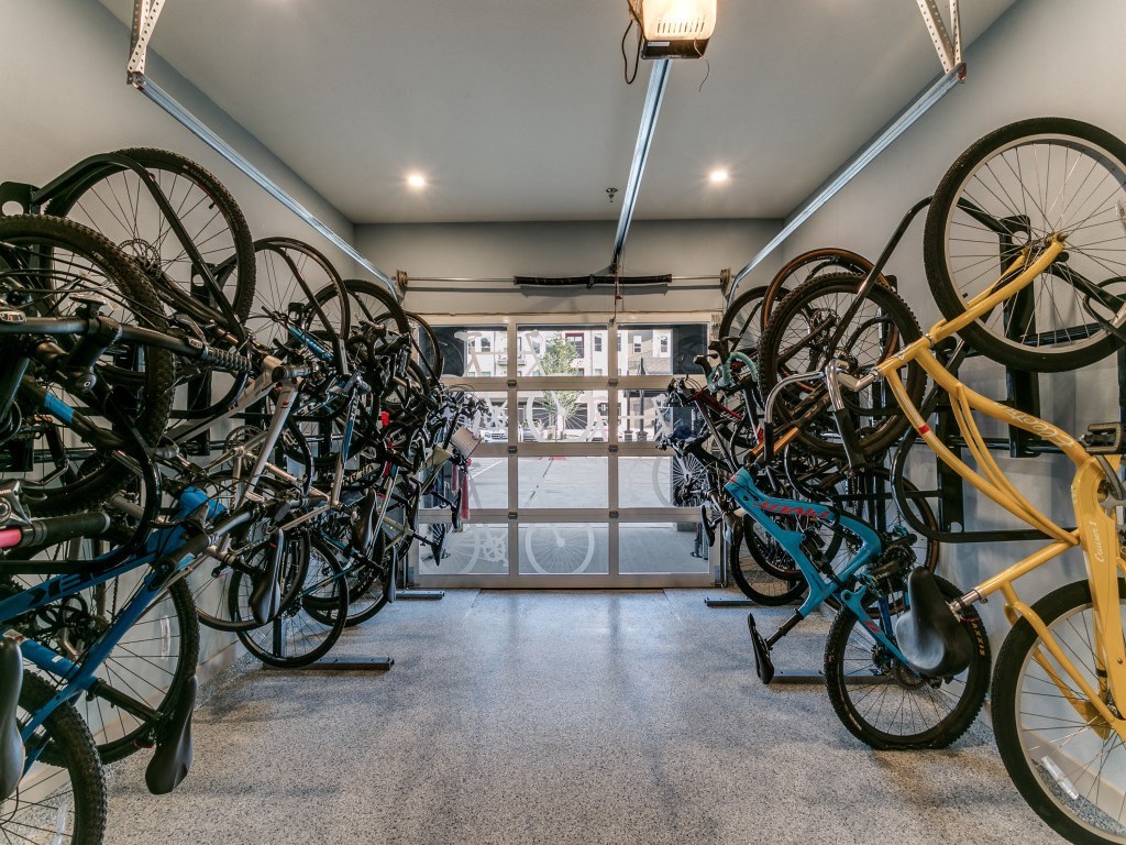 a bunch of bikes are hanging on the wall in a room