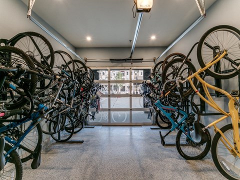 a bunch of bikes are hanging on the wall in a room