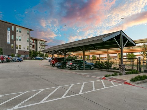a parking lot with cars in front of a building