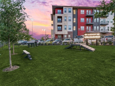 a park with benches in front of an apartment building