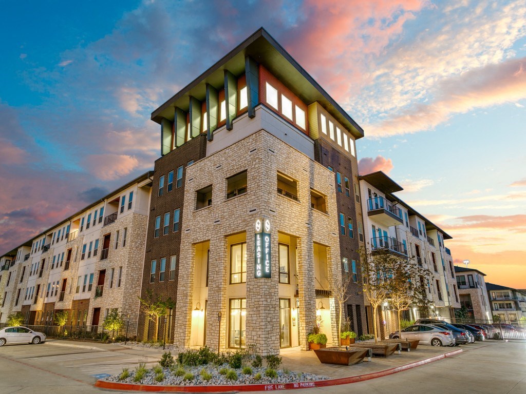a rendering of a building with a sunset in the background