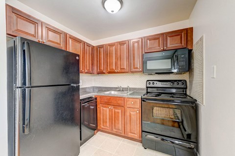 a kitchen with stainless steel appliances and wooden cabinets