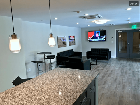 A modern office space with a bar counter and seating area.