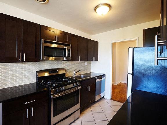 a kitchen with a stove and a refrigerator