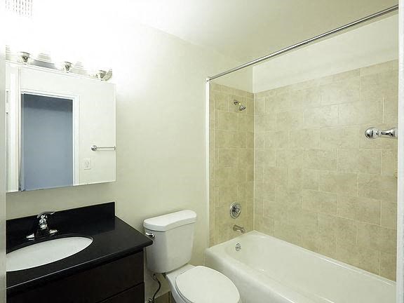 a bathroom with a sink toilet and a bath tub