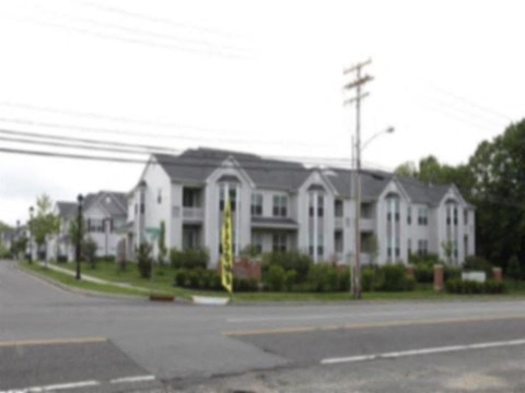 an apartment building on the corner of a street