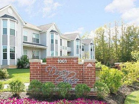 a brick sign in front of some houses