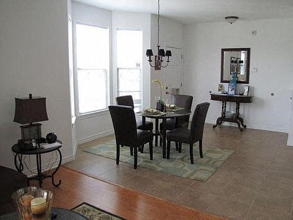 a dining room with a table and chairs
