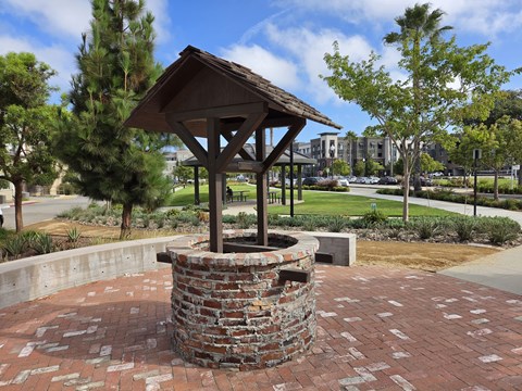 A gazebo is surrounded by a brick wall.