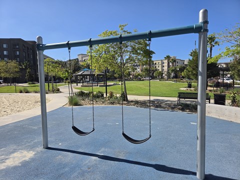 A playground with a swing set and a sandbox.
