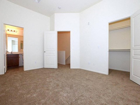 an empty living room with a door to a closet