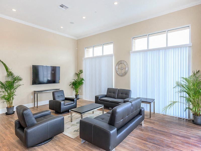a living room with leather furniture and a television