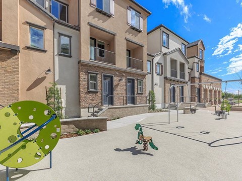 a dog playing with a frisbee in front of some apartments