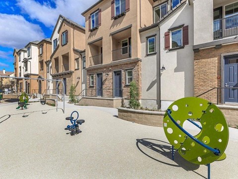 an outdoor basketball court in front of an apartment building