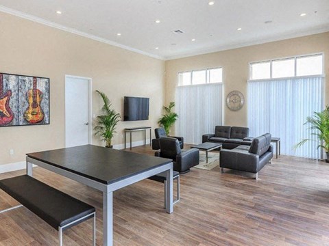 a living room with a table and chairs