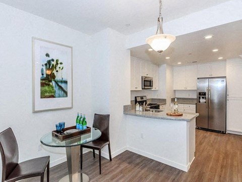 a kitchen and dining room with a table and chairs