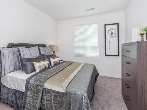 a bedroom with a bed and a dresser