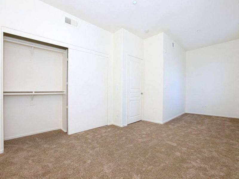 an empty room with white walls and a closet