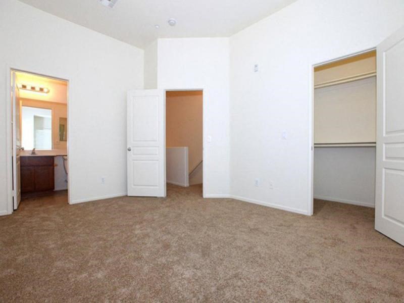 an empty living room with white walls and a closet
