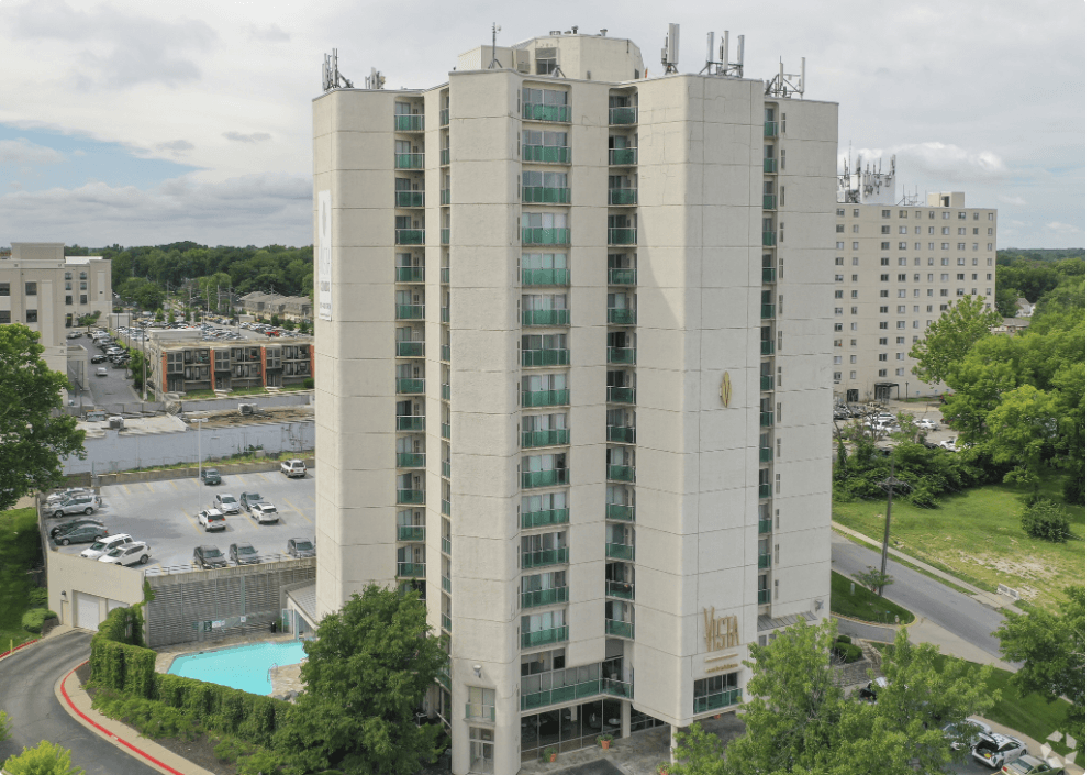 a view of a tall building from above with a parking lot at Vista Condominiums, Kansas