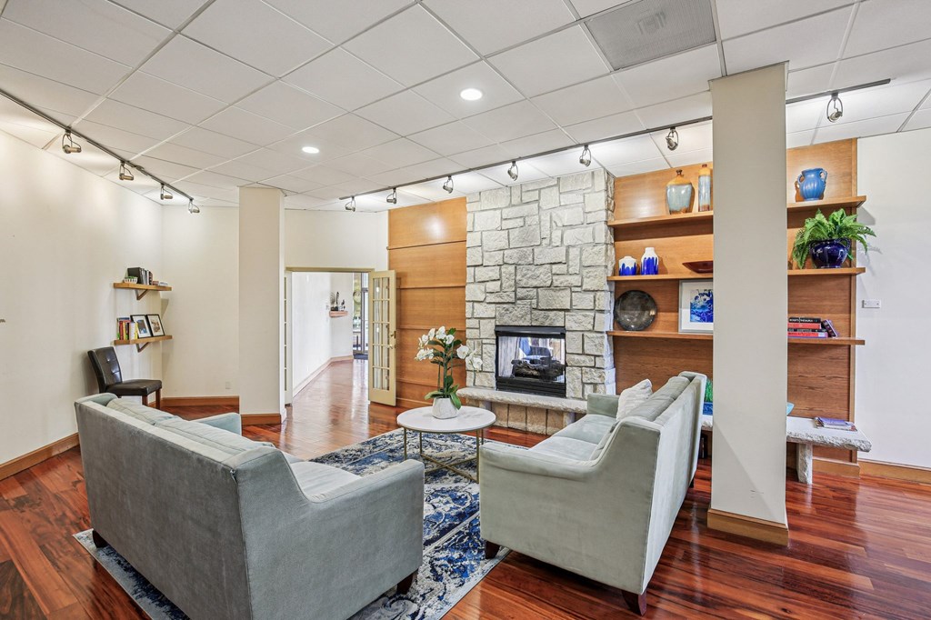 A living room with a grey couch and a white chair.