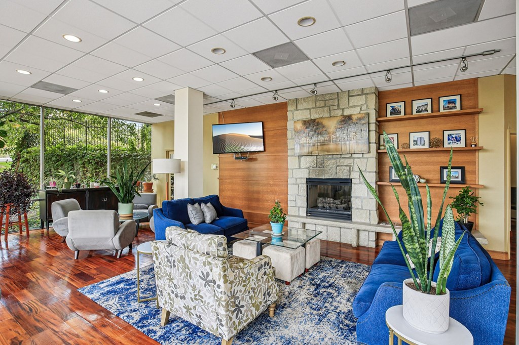 A living room with a fireplace and a TV mounted on the wall.