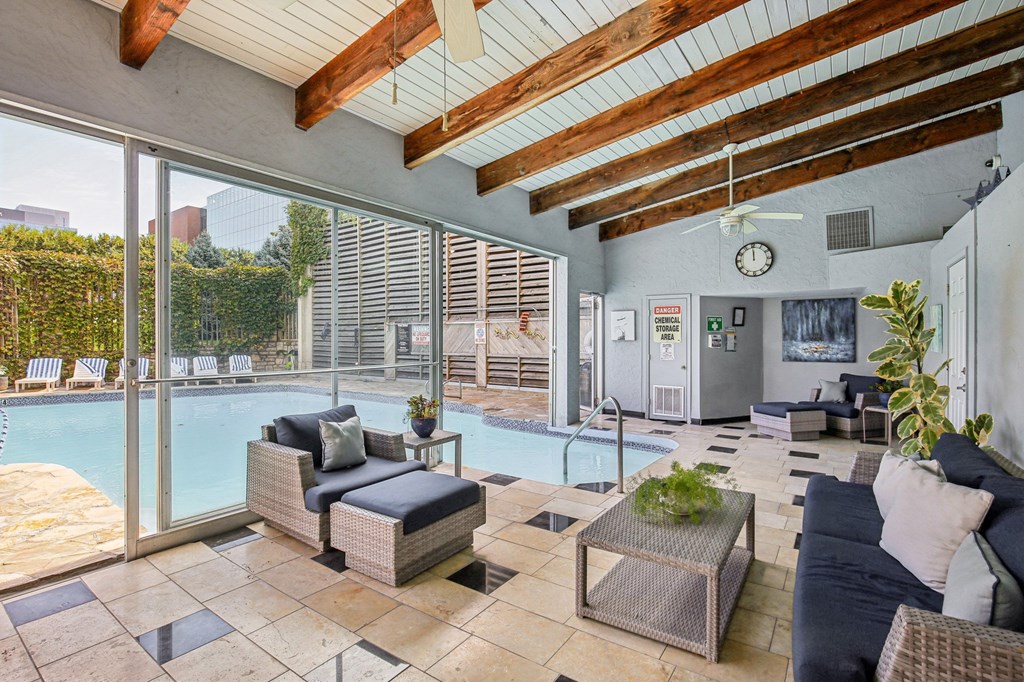 A patio with a pool and furniture.