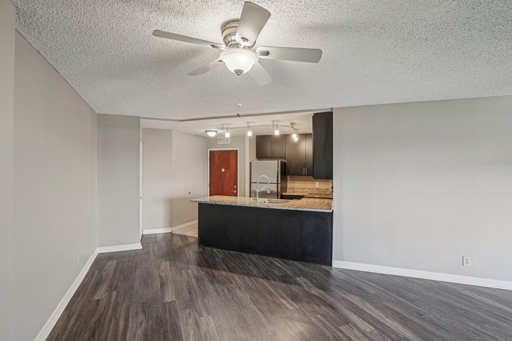 A room with a ceiling fan and a counter.