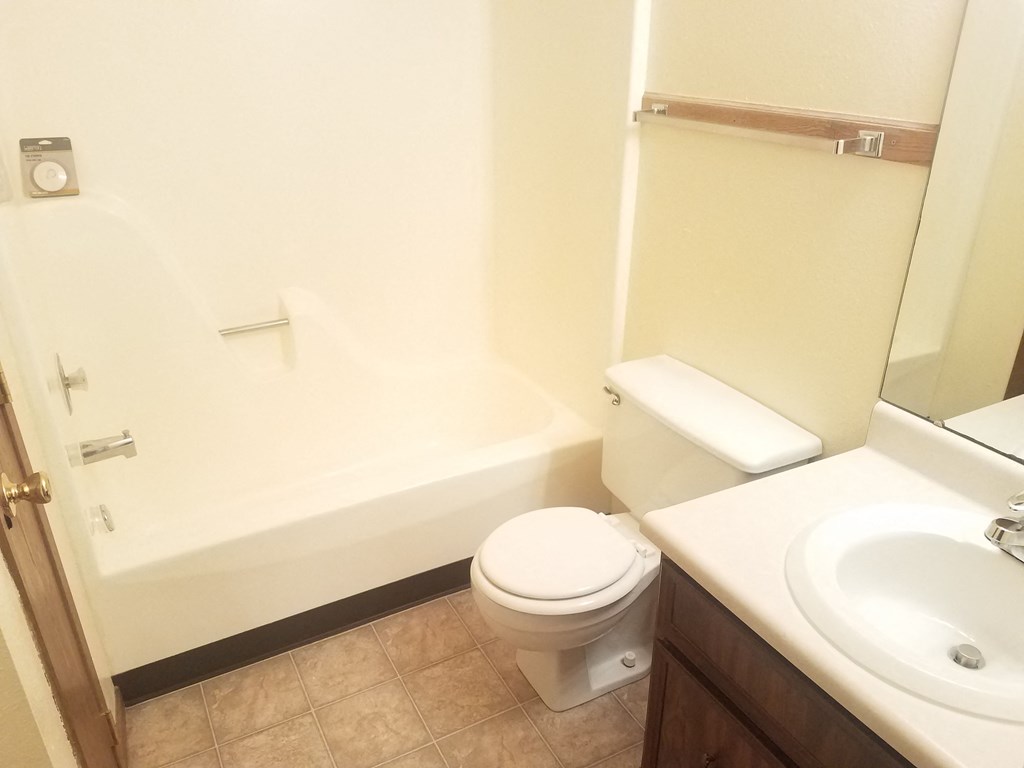 a bathroom with a sink toilet and a bath tub