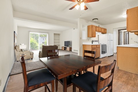 A dining room with a wooden table and chairs. at Winding Hills Apartments, Iowa