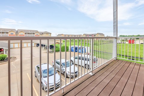 A parking lot with cars and apartment buildings in the background. at Deer Valley Apartments, Silvis, 61282
