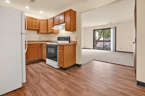 A kitchen with wooden cabinets and a white refrigerator.
