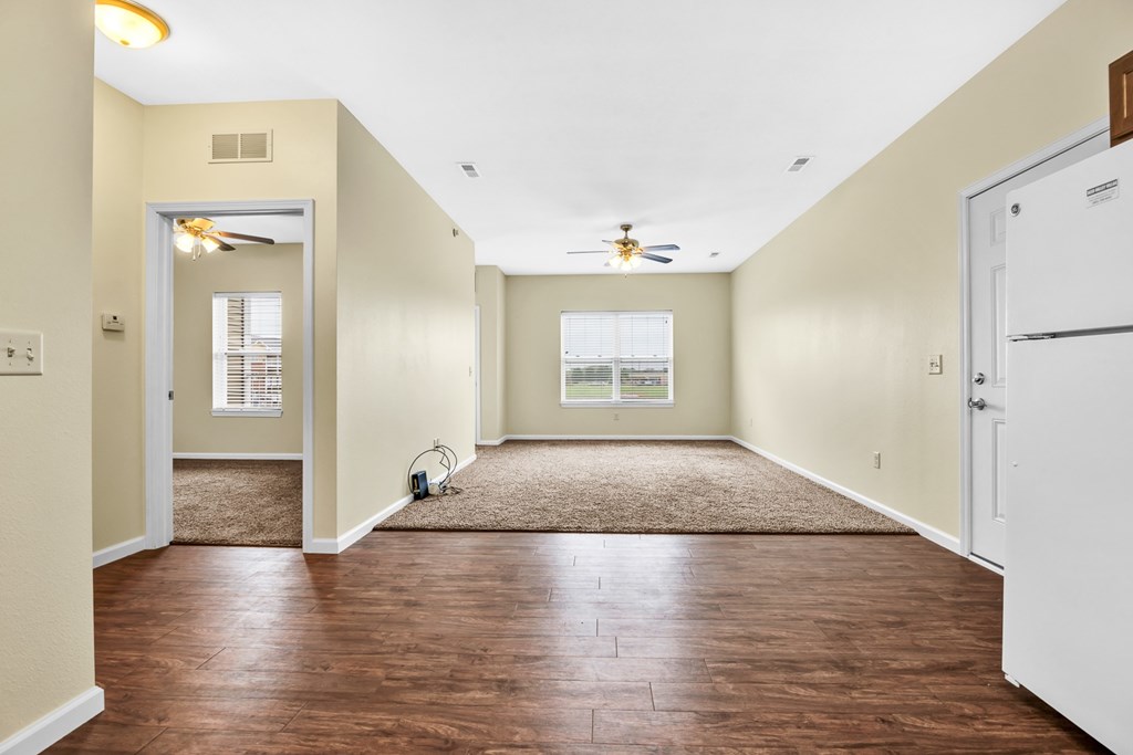 A room with a brown floor and a white ceiling.