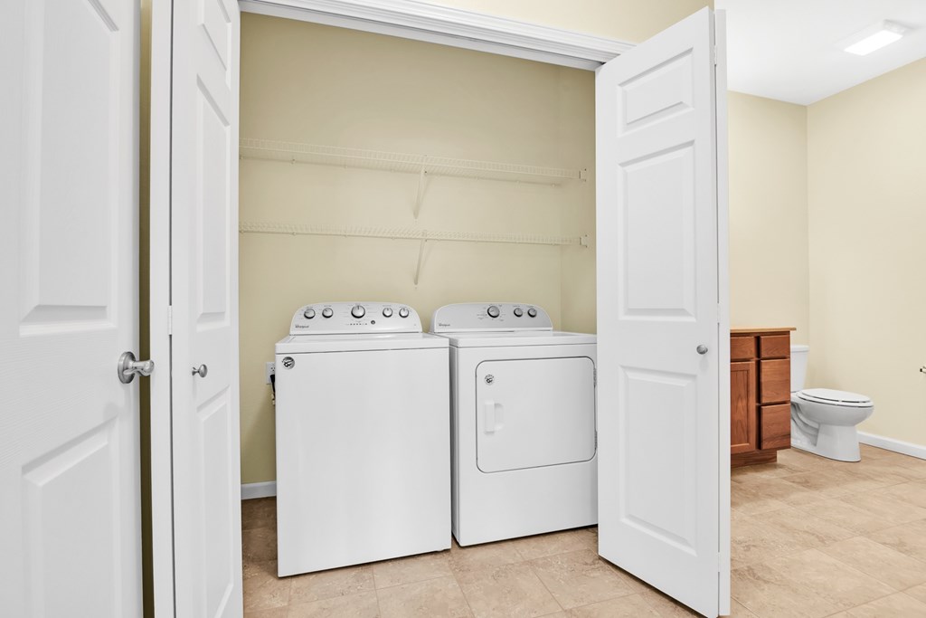 A laundry room with a washer and dryer in it.